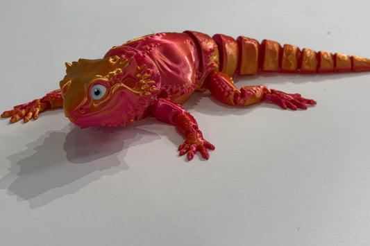 Colorful lizard figurine on a white background